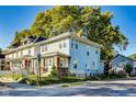 Charming two-story home featuring a brick foundation and light blue siding at 3470 N Kenwood Ave, Indianapolis, IN 46208