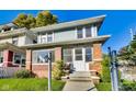 Charming two-story home featuring a brick foundation and light blue siding at 3470 N Kenwood Ave, Indianapolis, IN 46208