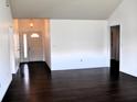 Spacious living room with gleaming hardwood floors, freshly painted white walls, and ample natural light at 3513 Berkdale Dr, Columbus, IN 47203