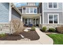 Inviting front porch with comfortable seating and stone accents at 3645 Conifer Dr, Zionsville, IN 46077