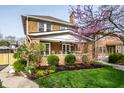 Beautiful brick home with a welcoming front porch and professionally landscaped yard with mature bushes at 3652 N Delaware St, Indianapolis, IN 46205