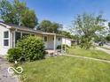 Single story home with large front window, greenery, and sidewalk at 428 E Trevor St, Brownsburg, IN 46112