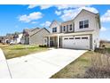 Traditional two-story home featuring a two-car garage and neutral-colored siding at 4345 Maize Ln, Whitestown, IN 46075