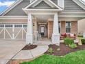 Inviting front porch with rocking chair, brick accents, and walkway leading to the front door at 4993 Silverbell Dr, Plainfield, IN 46168