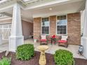 Cozy outdoor patio seating area with bird bath and lush landscaping at 4993 Silverbell Dr, Plainfield, IN 46168