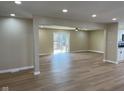 Spacious living room with new flooring and a sliding door leading to a deck at 5105 Manning Rd, Indianapolis, IN 46228