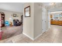 Spacious hallway featuring ceramic tile and providing access to the living room and kitchen at 5524 Cherry Blossom Ct, Indianapolis, IN 46237