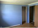 Bedroom with hardwood floors, blue painted walls and a closet ready to be customized at 5961 N 200 W, Columbus, IN 47201