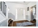 Inviting foyer with hardwood floors, neutral paint, and a staircase leading to the upper level at 6134 Chadsworth Way, Lawrence, IN 46236