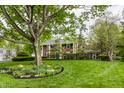 Classic brick home with a spacious lawn, mature trees, and well-manicured landscaping at 650 Forest Blvd, Indianapolis, IN 46240