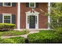 Close-up of a beautiful brick home's front entrance, showcasing the door, address, and landscaping at 650 Forest Blvd, Indianapolis, IN 46240