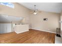 Open concept living room with a ceiling fan, hardwood floors, stairs to the upper level, and a bright, airy feel at 652 Blossom Dr, Avon, IN 46123