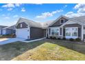 Inviting one-story home with neat lawn, lovely landscaping, and a convenient two-car garage at 7111 Lillian Pl, Cumberland, IN 46229