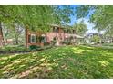 Well-maintained two-story brick house with lush lawn and mature trees at 7138 Avalon Trail Ct, Indianapolis, IN 46250