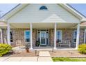 A cozy front porch features seating and decorative plants, enhancing the home's curb appeal at 8654 N Baltimore Rd, Monrovia, IN 46157