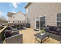 Outdoor patio with a table, grill, comfortable wicker furniture, and a sliding glass door at 8834 Pin Oak Dr, Zionsville, IN 46077