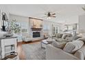 Spacious living room with a brick fireplace, large windows, and hardwood floors at 8834 Pin Oak Dr, Zionsville, IN 46077