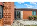 Close up of the front entrance featuring brick facade and clear view through the glass door at 9242 Golden Leaf Way, Indianapolis, IN 46260
