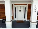 Welcoming front entrance with a white door, decorative wreath, and covered porch at 109 S County Line Rd, , IN 47272