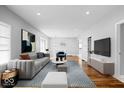 Bright living room featuring hardwood floors, modern furnishings, and an open floor plan at 1310 N Chester Ave, Indianapolis, IN 46201