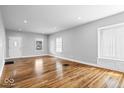 Spacious living room showcasing hardwood floors, ample natural light, and neutral paint at 1310 N Chester Ave, Indianapolis, IN 46201