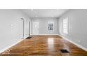 Light-filled living room with hardwood floors, crisp white trim, and a welcoming atmosphere at 1310 N Chester Ave, Indianapolis, IN 46201