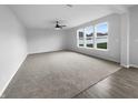 A spacious living room offers plush carpeting, neutral walls, and multiple windows for natural light at 13211 N Landing W Cir, Camby, IN 46113