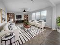 Bright living room features neutral decor, stylish furniture, and natural light from the large windows at 13211 N Landing W Cir, Camby, IN 46113