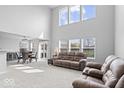Open-concept living room and dining area with high ceilings and lots of natural light at 15444 Old Pond Cir, Noblesville, IN 46060