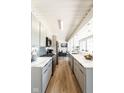 Sleek kitchen with stainless steel appliances and stone countertops open to the living space at 1802 Bellefontaine St, Indianapolis, IN 46202