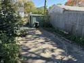 Open backyard featuring gravel area with shed, foliage and partial fencing at 1952 N Colorado Ave, Indianapolis, IN 46218