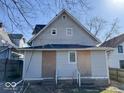 Rear exterior view of a two-story home with light gray siding showing covered back entrances at 2148 Singleton St, Indianapolis, IN 46203