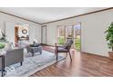 Inviting living room with laminate flooring, bay window, and neutral decor at 25249 State Road 13 N, Noblesville, IN 46060