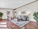 Bright living room with laminate flooring, stylish decor, and a comfortable seating area at 25249 State Road 13 N, Noblesville, IN 46060