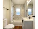 Modern bathroom featuring marble-look tile, sleek black fixtures, and bright lighting for a spa-like experience at 2528 E 17Th St, Indianapolis, IN 46218