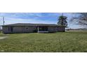 Expansive backyard featuring a screened-in patio and plenty of green space for outdoor activities at 3002 W 53Rd St, Anderson, IN 46011