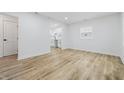 Bright living room featuring modern wood flooring, fresh white paint, new trim and lots of natural light at 3105 N Tacoma Ave, Indianapolis, IN 46218
