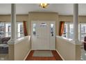 Bright and inviting foyer with a white front door, wood floors, and neutral walls at 320 Legacy Blvd, Greenwood, IN 46143