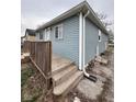 Exterior view showing light blue siding, white trim, and wooden porch steps at 3240 Collier St, Indianapolis, IN 46221