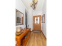 Inviting entryway with light wood floors, light colored walls, and console table with decor at 377 Van Buren St, Greenfield, IN 46140
