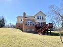 The backyard of this two-story home has a wood deck and brick chimney at 3926 Castle Rock Dr, Zionsville, IN 46077