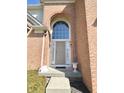 Elegant arched entryway with glass features, flanked by sconces, leading to a stylish front door at 3926 Castle Rock Dr, Zionsville, IN 46077