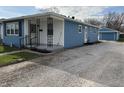 Attractive single Gathering home featuring a detached garage and spacious gravel driveway at 4121 Fletcher Ave, Indianapolis, IN 46203
