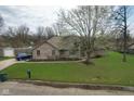 A beautiful brick home with a well-maintained lawn, mature trees and ample parking at 4808 N Camelot Dr, Muncie, IN 47304