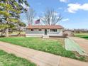 Attractive home boasting a spacious driveway and a detached garage, complemented by a well-kept lawn and mature trees at 533 E Ulen Dr, Lebanon, IN 46052