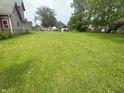 Large backyard with green grass and room for outdoor activities and entertainment at 554 N Tacoma Ave, Indianapolis, IN 46201
