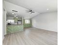 Open living space with vaulted ceiling, flowing into a renovated kitchen with new appliances at 6124 Dry Den Ct, Indianapolis, IN 46221