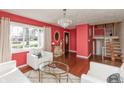Bright living room showcasing a chandelier, large window, hardwood floors, and elegant decor for comfortable living at 6340 Bluebell Ct, Indianapolis, IN 46224