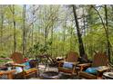 Outdoor fire pit surrounded by mature trees at 649 E Country Ln, Martinsville, IN 46151