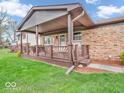 Inviting covered front porch featuring a stylish railing and attractive brick accents at 66 Coronado Rd, Indianapolis, IN 46234